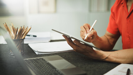 Man using digital tablet with stylus pen in the office