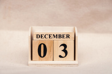 December 3rd. Image of December 3 wooden color calendar on white canvas background. empty space for text