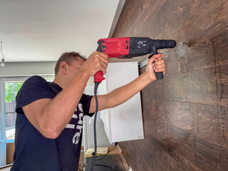 Interior renovation, handyman mounting wall bracket.