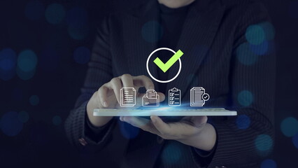 Businesswoman using tablet with digital checklist and approval checkmark icon, document management system concept, online verification, compliance audit, 