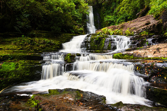cascading waterfall in a deep green forest