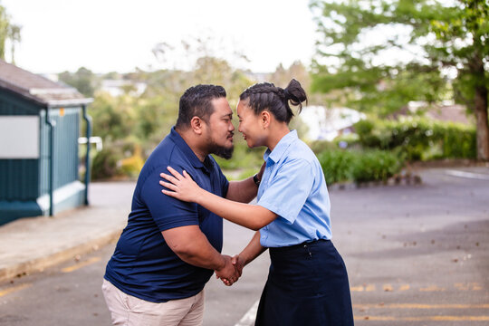 Samoan father and daughter doing traditional greeting - Hongi