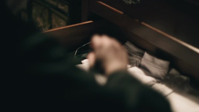 Person taking gloves out of drawer and putting them on
