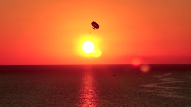Aerial Video of Paragliders Over Sunset Coastline
