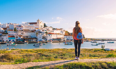Ferragudo fishing village evening summer view with boats on water, travel destination in Portugal,...