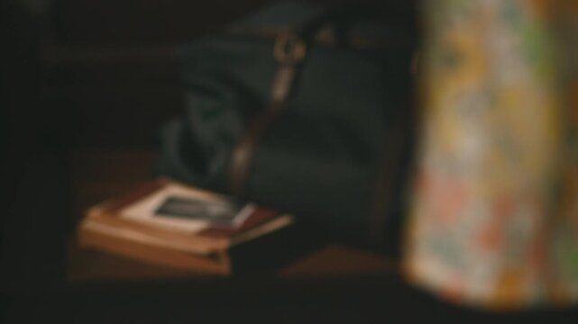 Ultrasound photo next to bag with floral dress and books