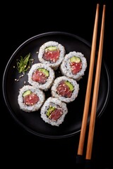 Tuna maki sushi rolls with avocado and sesame seeds on plate