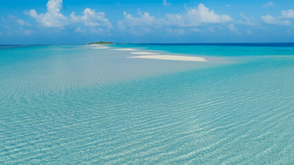 Summer lagoon Ripples in the sand at low tide on a beach with sandbar and blue sea in Maldives island