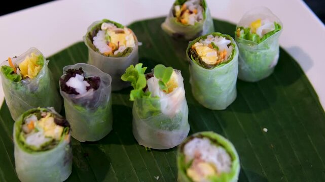 fried spring rolls nem drizzling savory sauce onto fresh Vietnamese pork rolls and herbs.