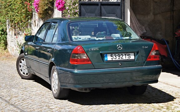 Mercedes-Benz C220 CDI sedan parked on a cobblestone driveway