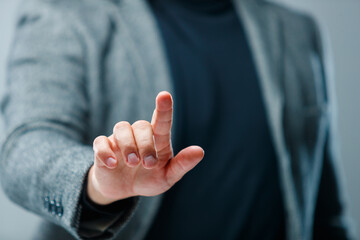 Obraz premium Close-up of businessman pressing imaginary digital interface as concept of technology and online services