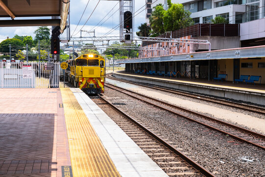 freight train coming through a station