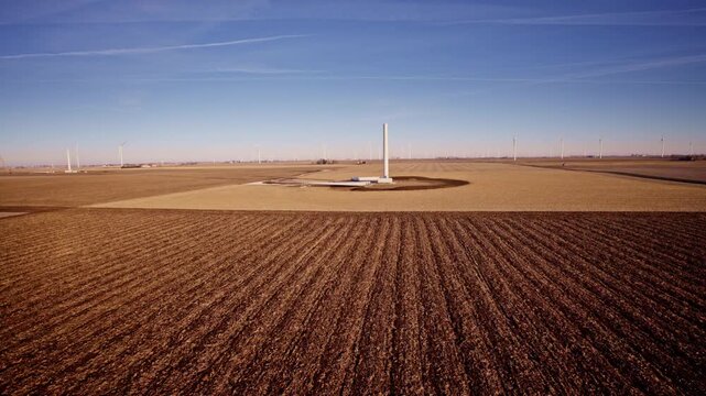 Expansive aerial shot slowly circling windmill construction zone