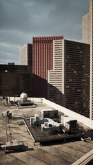 Obraz premium sunlit rooftop overlooking office towers with commercial facades, rooftop HVAC and service access, warm afternoon light, clear shadows and urban facility