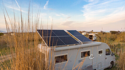 Caravan with tilt solar panels on roof. Aerial view. © Voyagerix