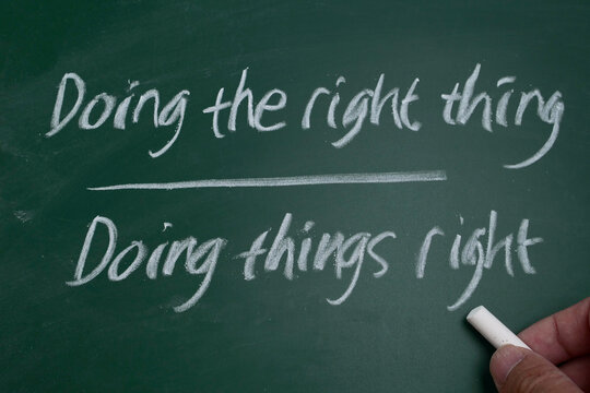 Motivational quote Doing the right things, handwritten in white chalk on a green chalkboard, business management and leadership efficiency concept