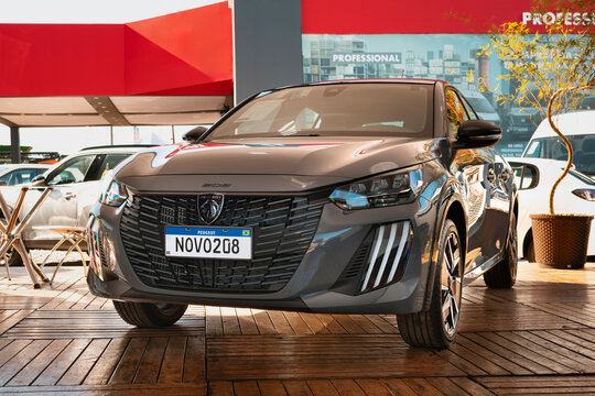 Peugeot 208 car with highlighting parametric grille, LED light signature, and bumper with integrated aerodynamic elements.