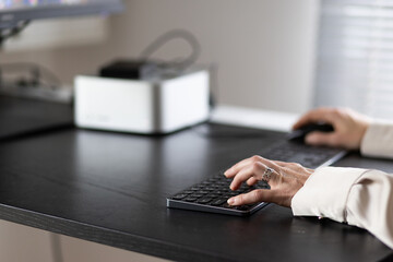 female hands typing on a keyboard