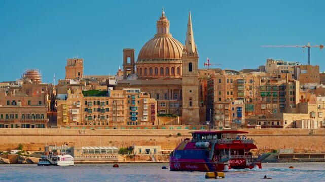 View of Valletta's of Capital City of Malta at sunny day. Marsamxett Harbour with the view on Valletta Saint Paul's Anglican Cathedral