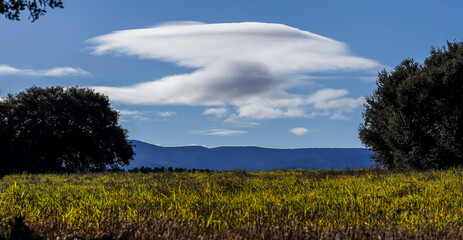 Panoramic landscape of a sea of clouds over a mountain valley at dawn