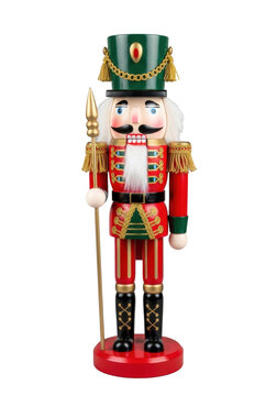 An intricately carved wooden nutcracker soldier wearing a red and green uniform with gold trim and shako hat, holding a golden spear, isolated on a transparent background. Concept of christmas holiday