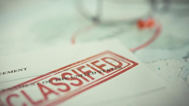 A confidential stamp in red ink marks classified documents on a diplomatic table, indicating interstate agreements require high security clearance and adherence to strict protocol