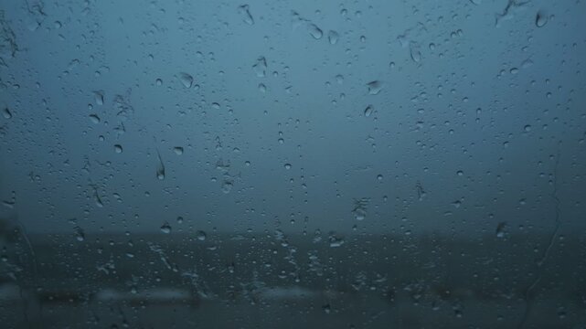 車の窓に落ちるみぞれ交じりの雨