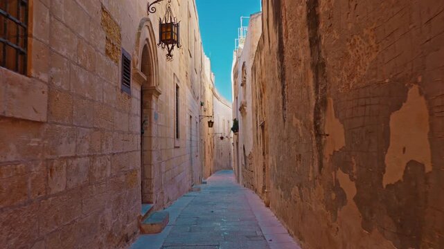 Amazing old town Mdina in Malta, walking narrow medieval city street made of limestone