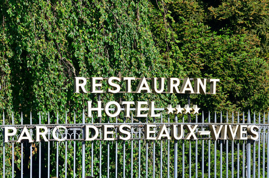Geneva, Switzerland, Europe - 05.2022 : H&ocirc;tel du Parc des Eaux-Vives, 4 star Hotel Restaurant Eaux-Vives (18th century) in Park Eaux-Vives (16th century), metal fence with welcoming information