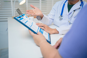 Male doctor consulting with female patient in a clinical examination room, documenting medical history, discussing symptoms, treatment plans, and prescriptions, reflecting professionalism, truste © M+Isolation+Photo
