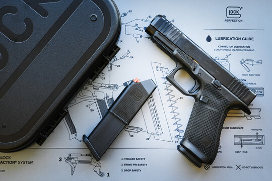 TALLINN, ESTONIA - FEBRUARY 19, 2026: A Glock 17 Gen 6 9mm pistol with a magazine on a lubrication guide mat.