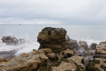 Waves crash against rocks at Seeaview on the Isle of Wight, UK