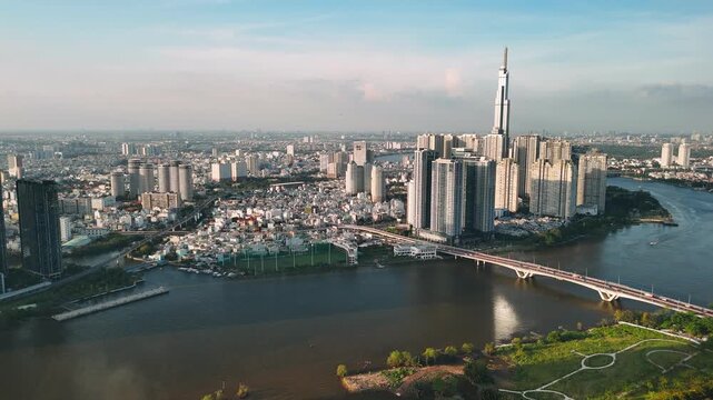Aerial view of ho chi minh city skyline with skyscrapers and saigon river at sunset, vietnam