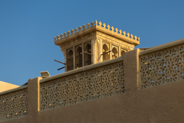 Views of Oriental buildings, sandstone walls and arches, windows and doors. On the streets of Dubai, in a public place.