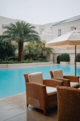 Fototapeta premium Luxurious outdoor poolside retreat with tropical ambiance on a rainy day