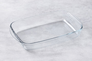 Clear rectangular glass baking pan, sleek kitchen tool, ideal for roasting, simple elegance, food...