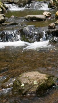 Mountain landscape river with balanced composition and flowing motion. Suitable for Vertical brand marketing, eco campaigns, and scenic content creation.