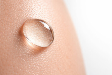 Fototapeta premium Close up image showcases droplet of water resting smooth skin, highlighting importance of hydration luxury skincare. texture of skin enhances