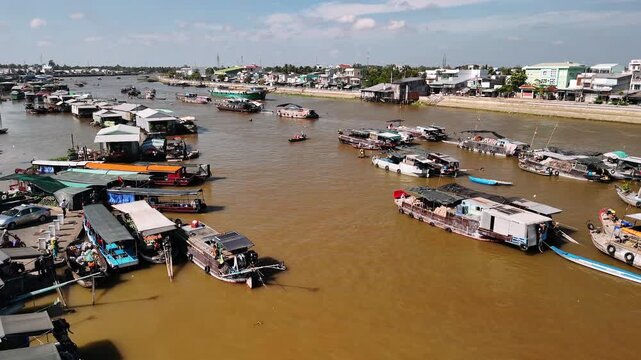 Aerial view of cai rang floating market with traditional boats sailing on the muddy mekong river in can tho, vietnam