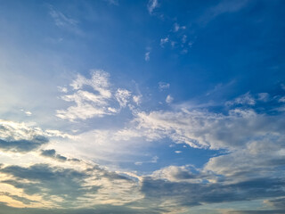 Fototapeta premium Dramatic blue sky with swirling white clouds creating a beautiful natural atmospheric background