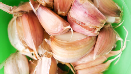 Garlic on green background.