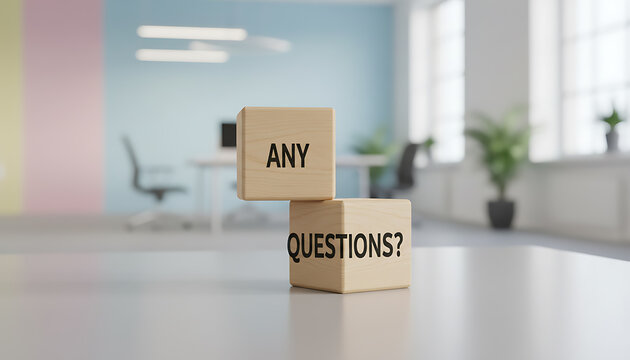 Two wooden blocks with text Any Questions stacked image