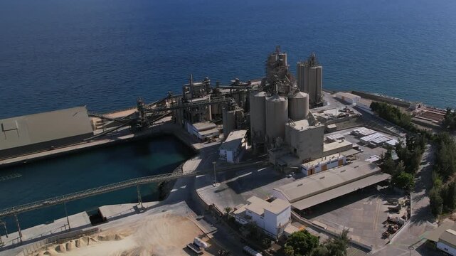 Industrial plant for cement production located on the coastline of Arguineguin, Gran Canaria. Aerial perspective of the factory complex