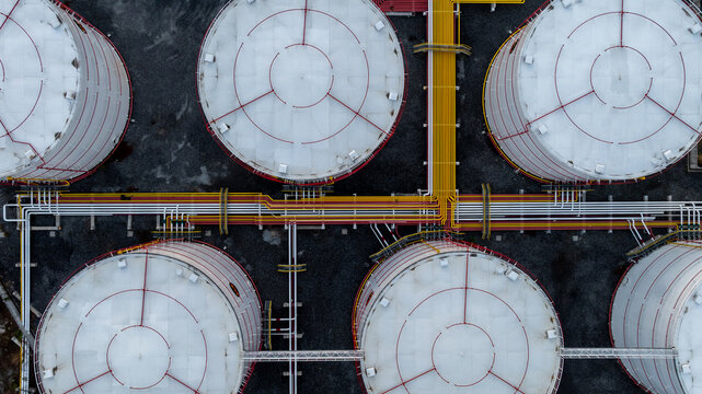 Aerial view white oil storage tank with pipeline steel, Crude oil industry, Storage fuel gas container tank petroleum refinery industrial factory, Oil storage chemical petrochemical refinery product.