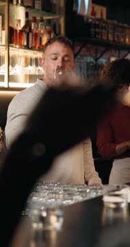 Barman, wine tasting and discussion with smell at restaurant for vintage, flavor profile and test. Person, bartender and guide with alcohol, drinks and social event at bar with customer experience