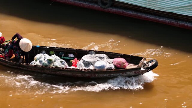 Vietnam vendor sailing on boat at cai rang floating market in the mekong delta, can tho, vietnam