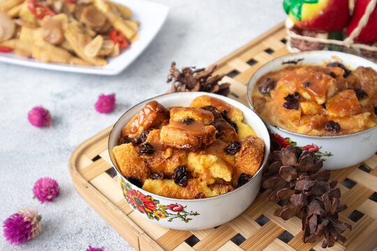 Puding roti, or bread pudding, is a classic dessert made from stale bread soaked in milk or cream, enriched with eggs, raisins, and butter, then baked to golden firmness. Best enjoyed warm.