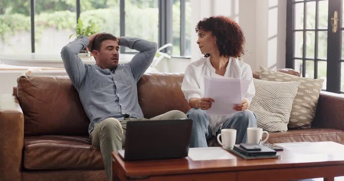 Talk, couple and paper in home for debt, bankruptcy or discussion for financial crisis with laptop. Interracial man, woman and document for bills on computer, expenses or stress for mortgage cost