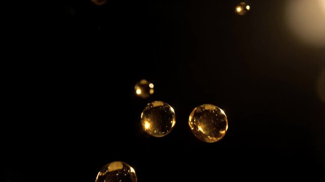 A close up of a bunch of gold bubbles floating in the air. The bubbles are small and shiny, and they seem to be suspended in midair. The image has a dreamy, ethereal quality to it