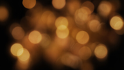 Beautiful soft focus golden bokeh lights on dark background for elegant festive design.